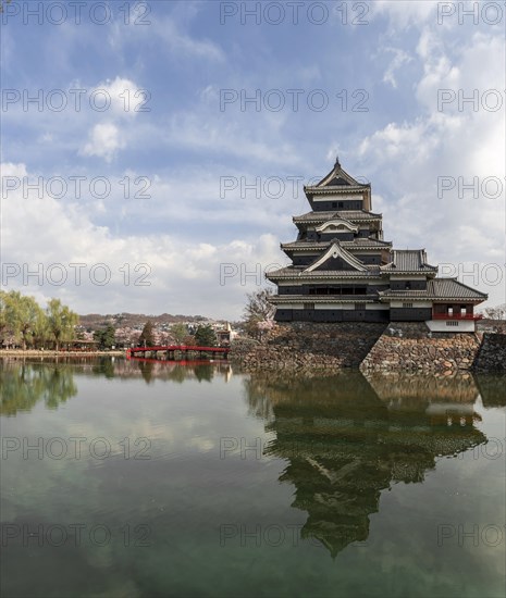 Old Japanese castle reflected in the moat