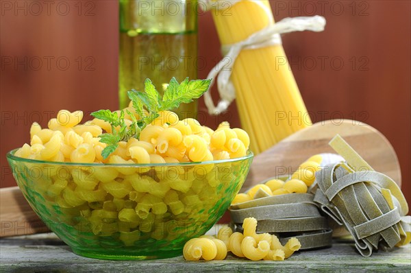 Various types of pasta with a glass bowl