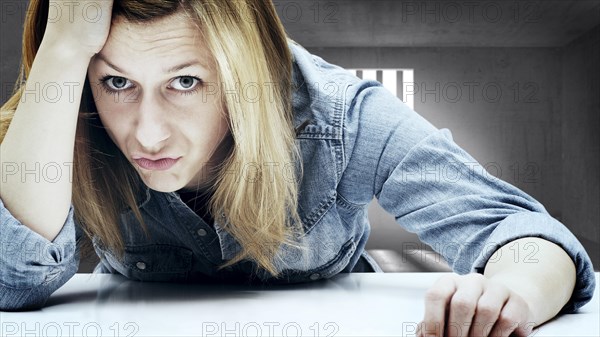 Young woman in a jail cell