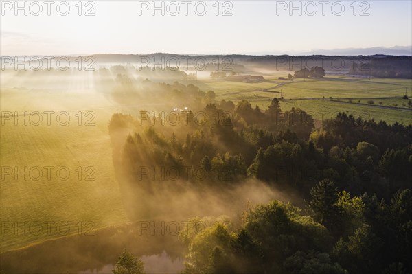 Cultural landscape with Loisach Canal in the morning fog