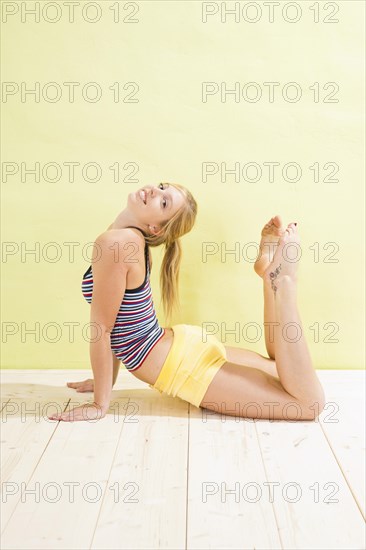 Young woman doing stretching and strengthening exercises