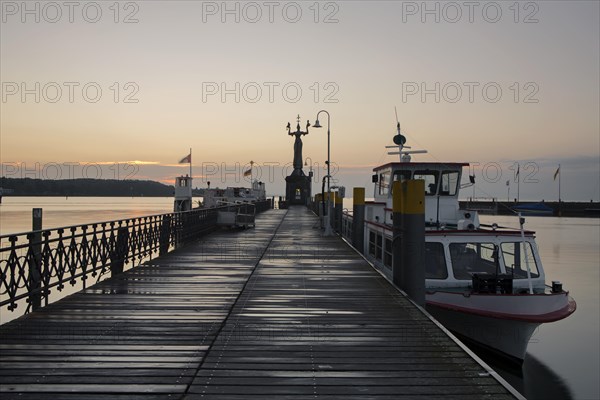 Morning light in the port of Konstanz with Imperia and a ship