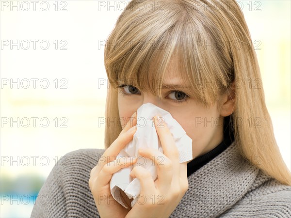 Young woman using a tissue