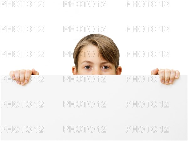 Schoolboy behind a white board