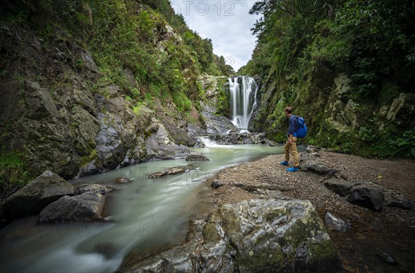 Hiker in front of Piroa Waterfall