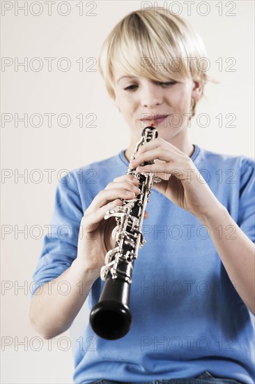 Teenage boy playing the oboe