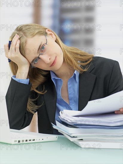 Businesswoman wearing glasses and using a laptop