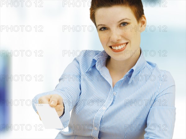 Businesswoman holding a blank business card