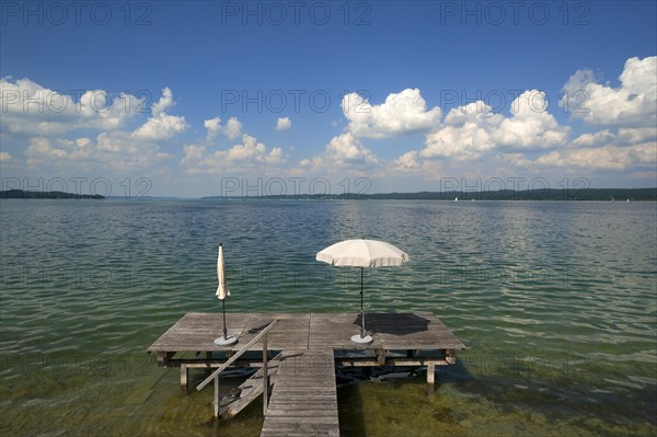 Lake Starnberg with bathing jetty and parasol