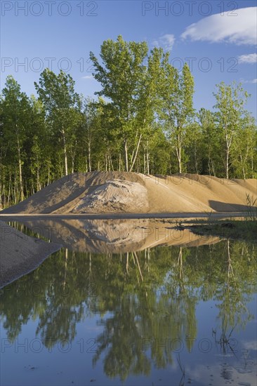Mounds of sand in a commercial sandpit after a heavy rainfall
