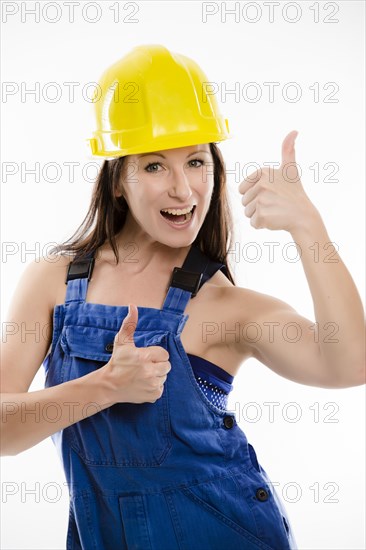 Woman wearing blue overalls and a hardhat