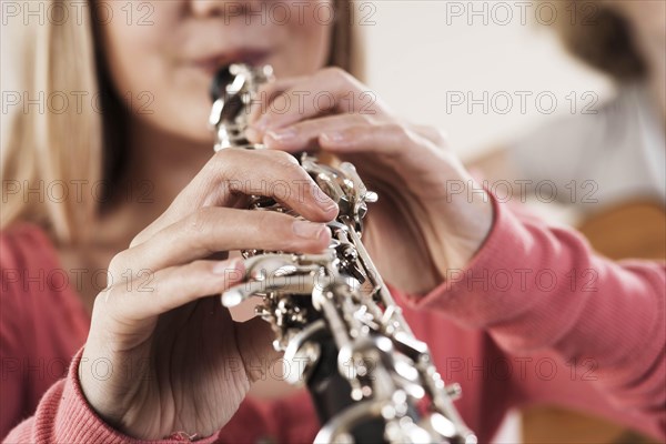 Teenage girl playing the oboe