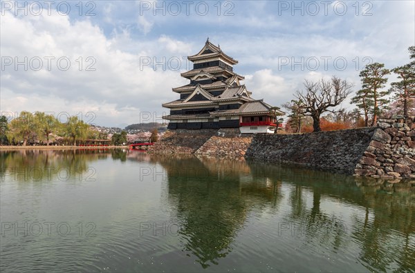 Old Japanese castle reflected in the moat