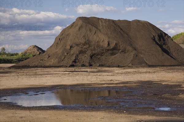 Mound of topsoil in a commercial sandpit after a heavy rainfall