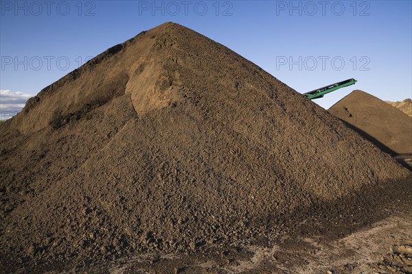 Stacking conveyor and mounds of sand in a commercial sandpit