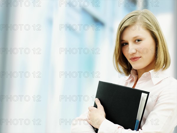 Businesswoman holding a ring binder