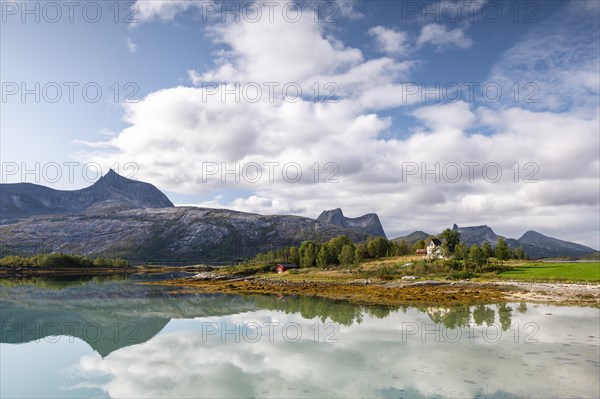 Mountains and landscape reflected in fjord