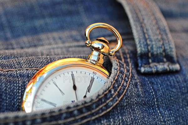 Pocket watch in a jeans pocket