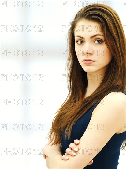 Young woman with her arms crossed