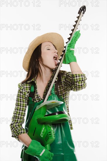 Female gardener holding a hedge trimmer