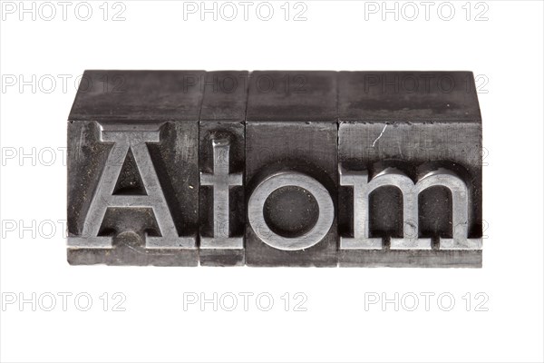 Old lead letters forming the word 'Atom'