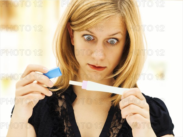 Woman holding a pregnancy test