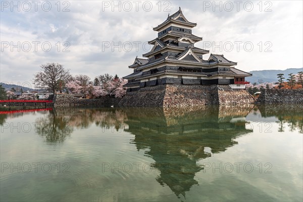 Old Japanese castle reflected in the moat