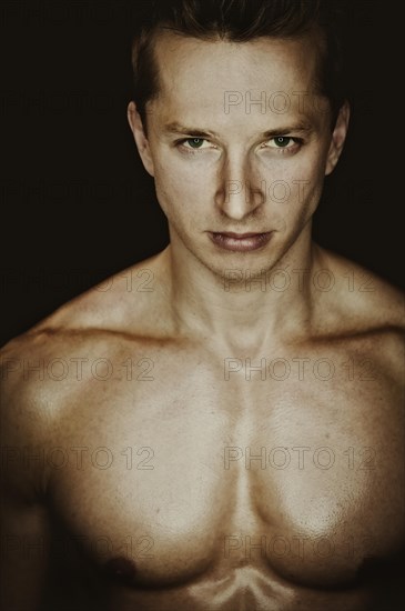 Young man with a muscular upper body