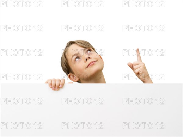 Schoolboy behind a white board