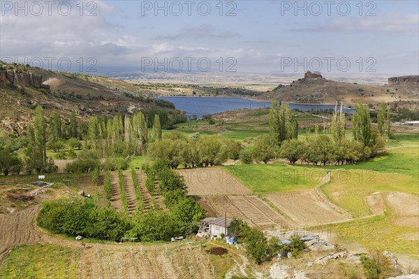 Fields and Yuksek Kilise or High Church at Guzelyurt