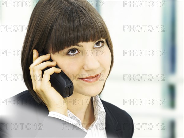 Businesswoman using a telephone