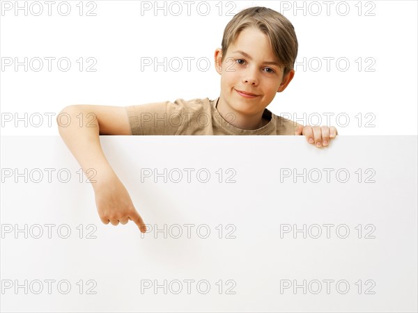 Schoolboy behind a white board