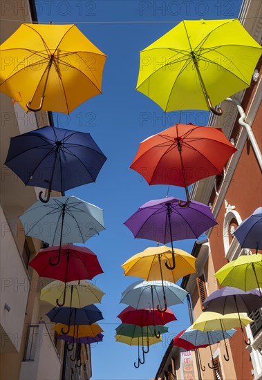 Colorful umbrellas over a road