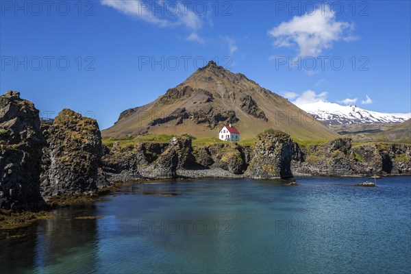 Lonely house on the basalt coast near the harbour