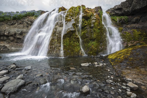 Fossarett waterfall with river Fossa at fjord Hvalfjorour