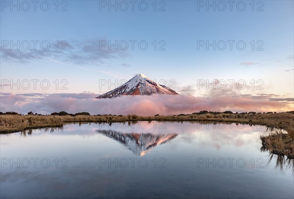 Water reflection in Pouakai Tarn Mountain Lake at sunset