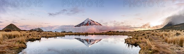 Water reflection in Pouakai Tarn Mountain Lake at sunset