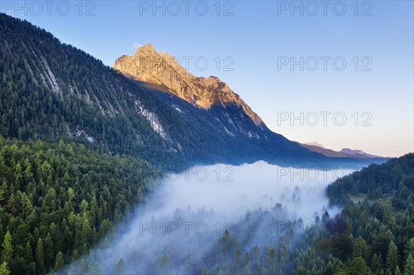 Wettersteinspitze and fog above Ferchenseehohe at sunrise