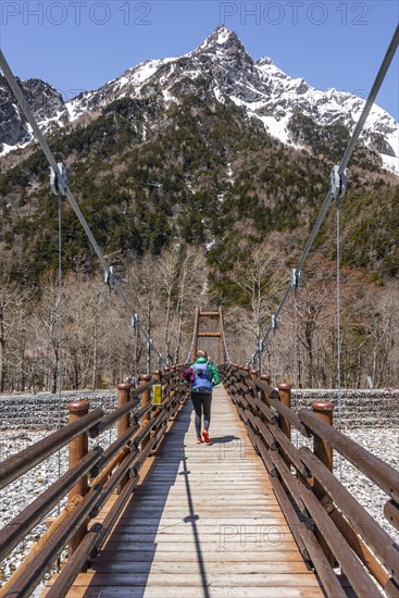 Woman walking over Myojin Bridge