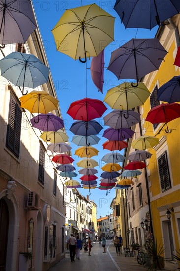 Colorful umbrellas over a road