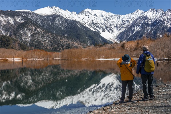 Two Japanese tourists at a lake