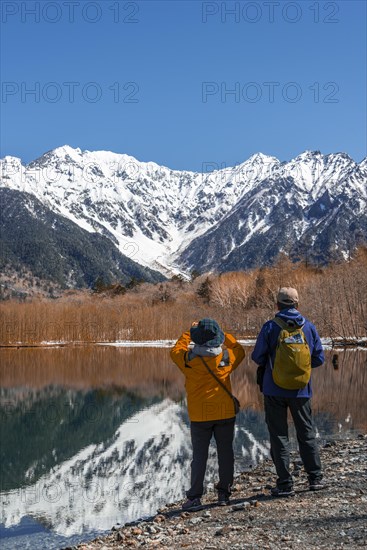 Two Japanese tourists at a lake