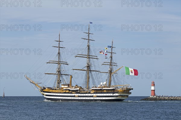 Italian sailing training ship Amerigo Vespucci passes pier lights at the entrance to the Unterwarnow