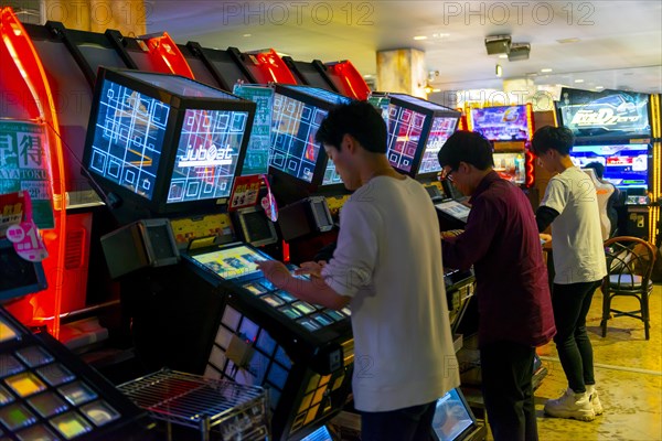 Teenagers play Jubeat