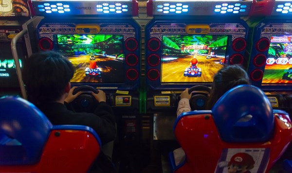 Teenagers play a car racing game