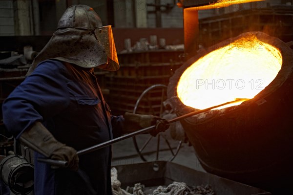 Worker on tanks with liquid iron