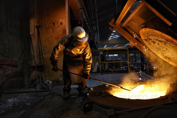 Worker on tanks with liquid iron