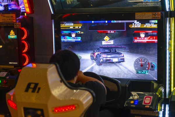 Teenager plays a car racing game