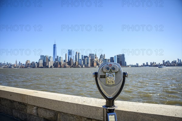 Telescope on Ellis Island overlooking the skyline of Lower Manhattan