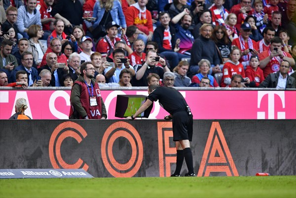 Referee Referee Marco Fritz watch video evidence on monitor